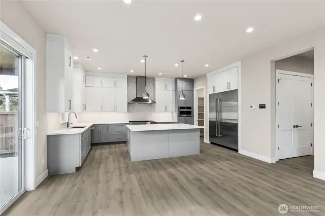 Kitchen is open plan, modern and roomy with high end appliances, gas range and custom lighting.