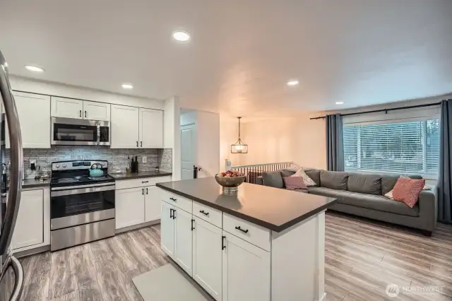 Kitchen with island and family room.