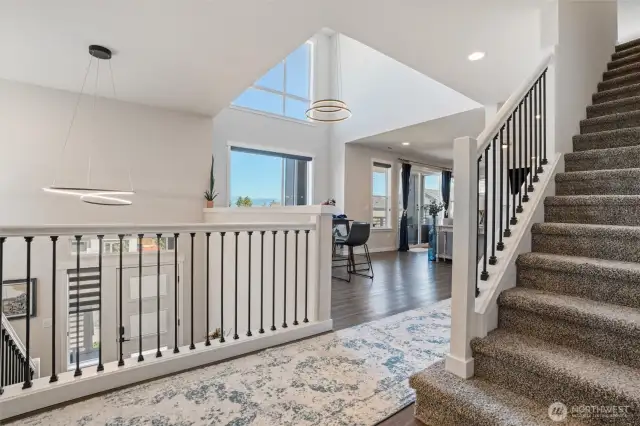 Stepping up from the entrance to the living and dining room with oversized windows to take in the views.  Stairs to 3rd floor.