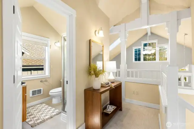 Nice railing overlook to the area below and 3/4 bath of the upstairs primary bedroom