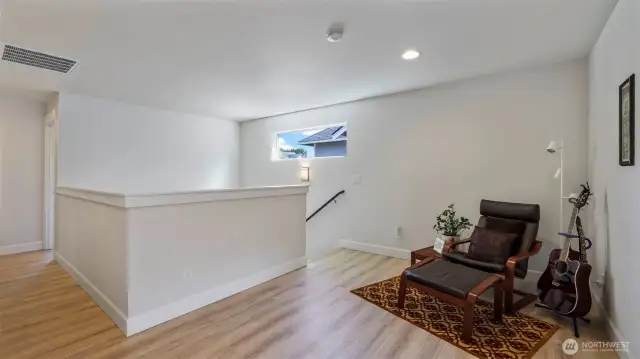Enjoy hardwood floors and an airy seating area just steps upstairs