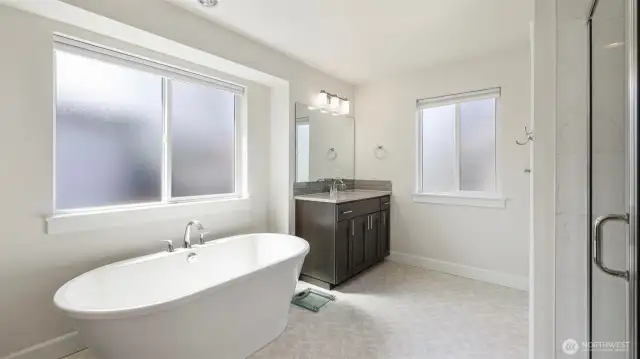 Indulge in tranquility with a spa-inspired bathroom and a spacious soaking tub