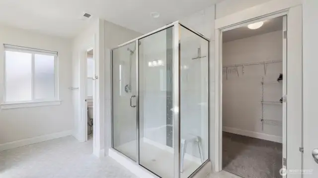 Generous walk-in closet located just beside the spacious walk-in shower in this private en suite bathroom