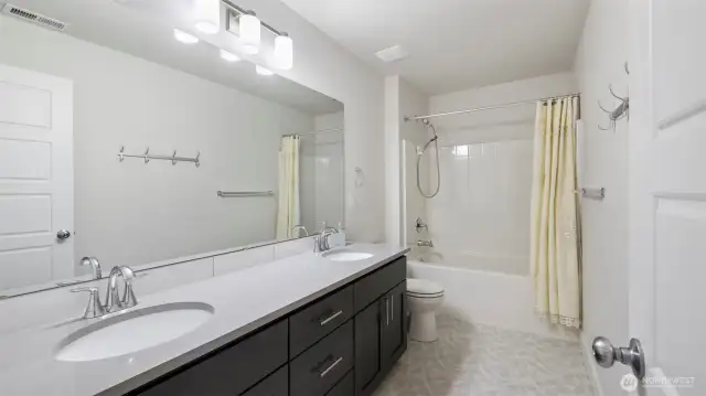 Guest-ready full bath upstairs featuring a double vanity for added comfort