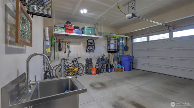 Roomy garage perfect for vehicles, gear, gatherings, and equipped with a handy sink