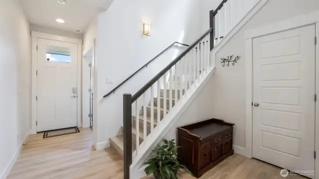 Beautiful hardwood flooring greets you upon entry, with easy access to the upstairs retreat
