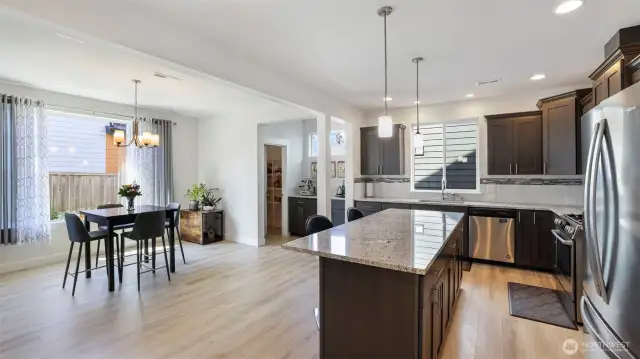 Sun-filled kitchen boasts a spacious walk-in pantry and an open dining area perfect for gatherings