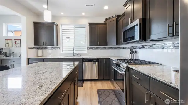 Granite countertops and generous cabinet space make this kitchen a dream for home cooks!