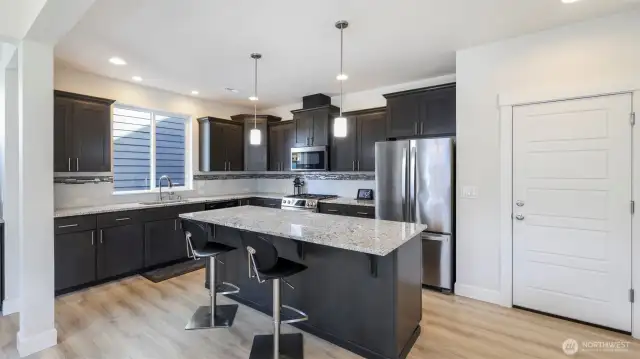 Generously sized island provides an ideal spot for gatherings, meals, and more