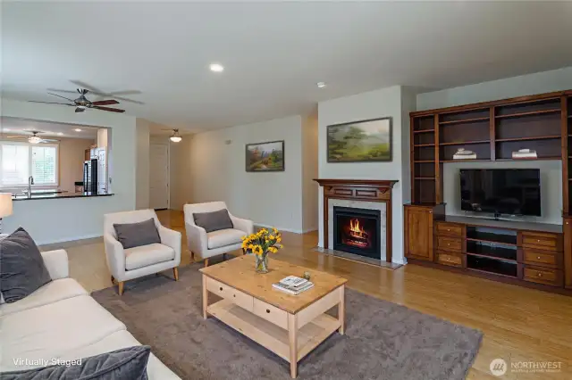 Open living room, complete with gas fireplace and custom built-in cabnetry.