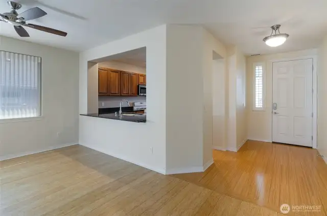 View of entry showing dining home and open window to kitchen, complete with breakfast bar.