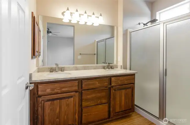 Primary bath has oversized walk-in shower, double sinks, and private toilet area.