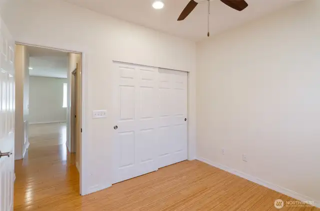 Another view, showing hallway into main living area and full bath adjacent on the left.
