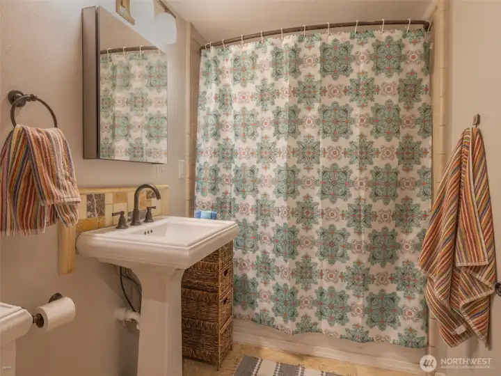A full bath with full tub and shower