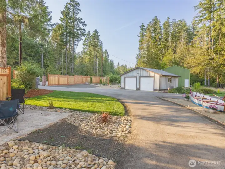 A nice circular driveway with hook ups for a trailer and lots of parking for guests and another conversation area with a firepit