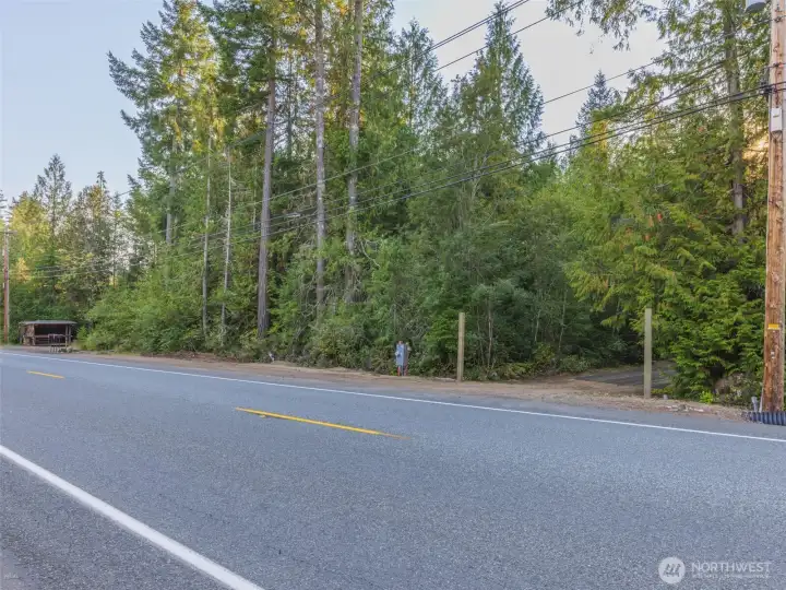 The second entrance on the included property across the street. It has power, the septic system and a drain field that can be expanded for new construction on this vacant parcel