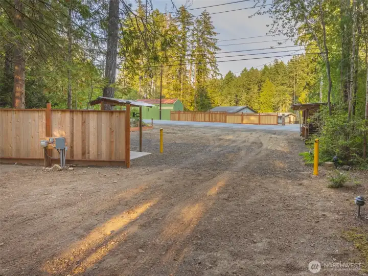 The view of the acreage entrance from across the street of the waterfront home
