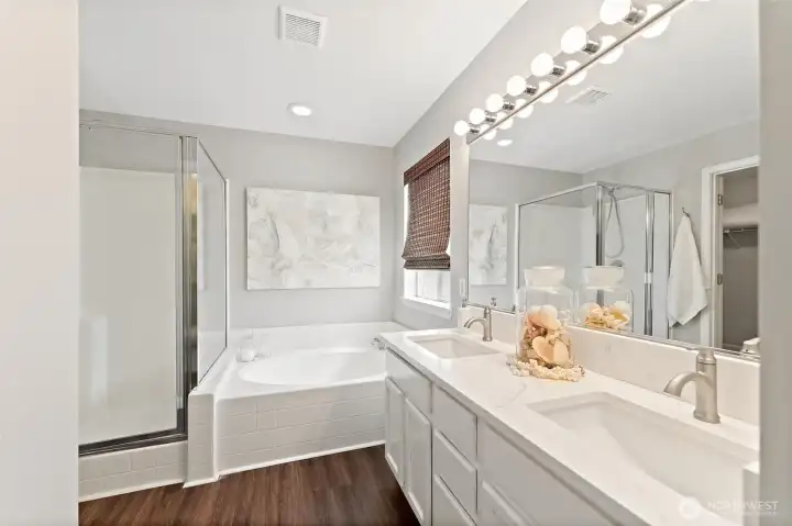 Dual sinks a soaking tub and walk in shower