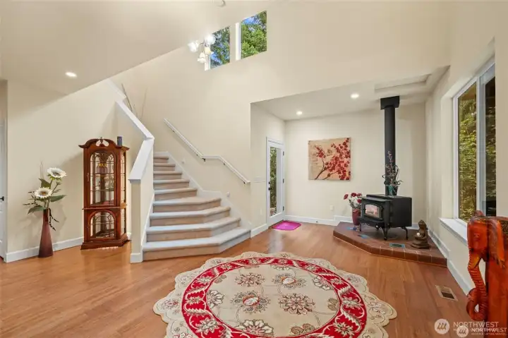 Soaring entry area with side door to gardens