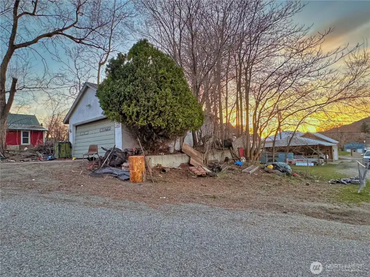 Detached garage with partial fenced parking area