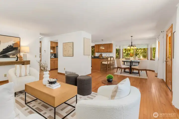 Hardwood floors wrap around the living room, dining room and kitchen. Plenty of windows give this large space a treehouse feel