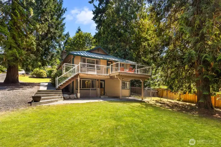 Rambler in the front, party in the back. Aside from the expansive deck up top, down below this home features a family room, a full bathroom, 3 bedrooms, a large utility room, it's own outdoor access complete with a fully fenced dog run area