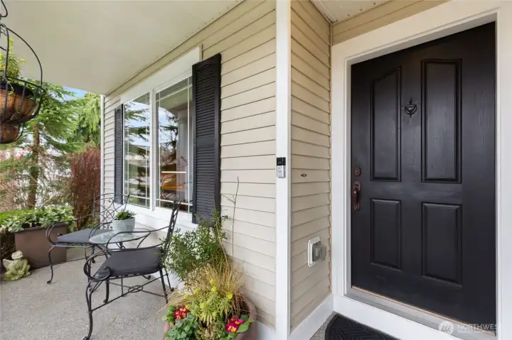 Relax and enjoy serene views from the covered front porch.