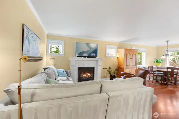 Living room opens to the dining area. Wood-wrapped windows have been added throughout.