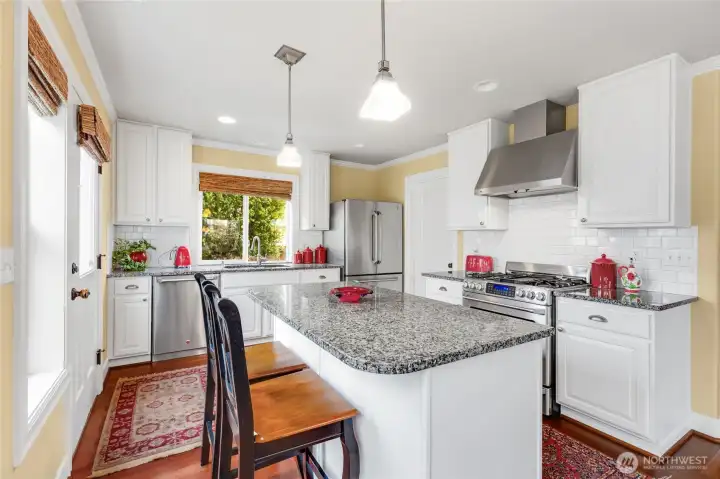 Well-appointed kitchen with slab granite island.