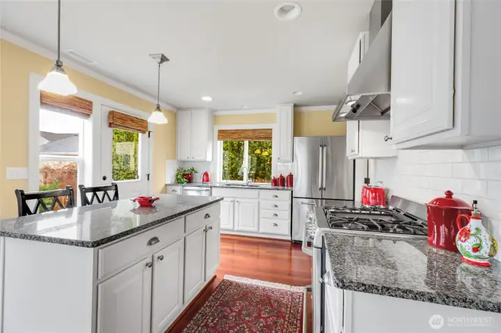 Stainless appliances and custom cabinets with pull-out drawers.