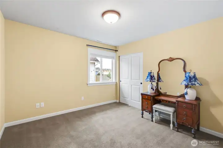Spacious third bedroom without the staging.