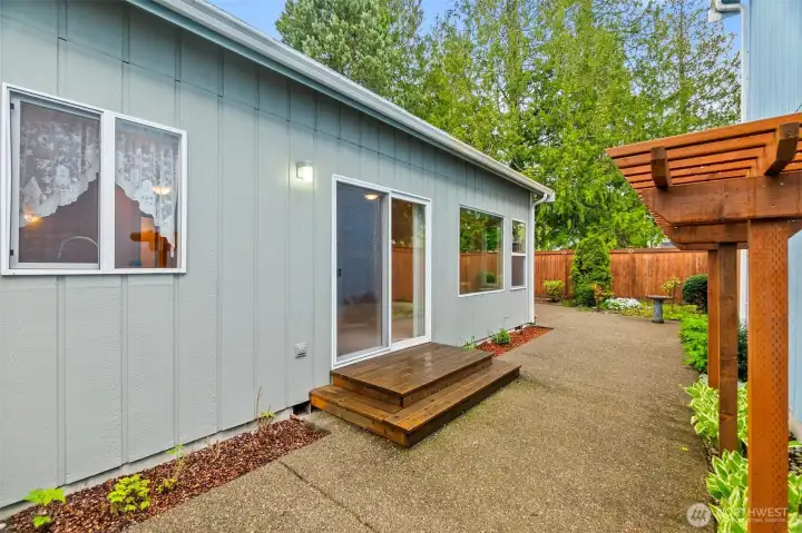 The side entrance to courtyard with trellis.