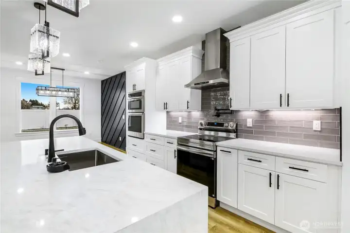 Spacious kitchen layout with modern finishes and functional design, reflecting the elevated standard included in this new construction home. Selections may vary.