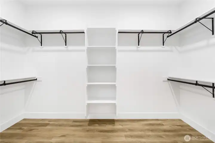 Functional and spacious primary closet design offering ample storage and organization.