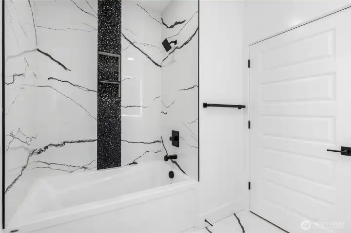 Full bathroom example with tile surround tub/shower and durable, modern finishes designed for everyday use.