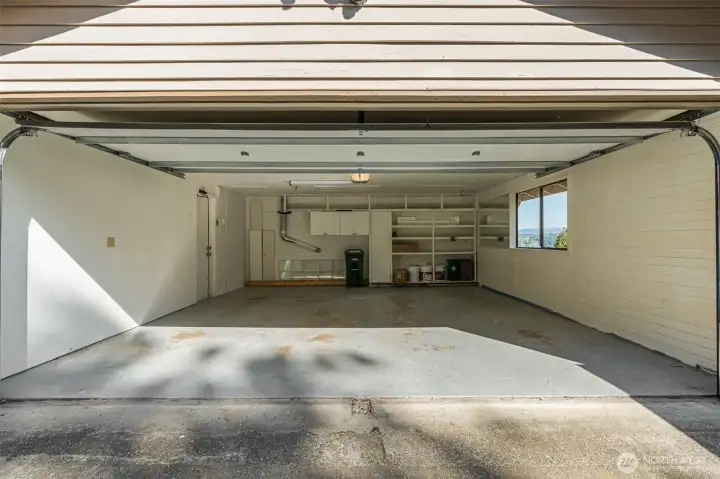2 car attached garage with attic storage and cabinets inside garage. Tons of storage space.