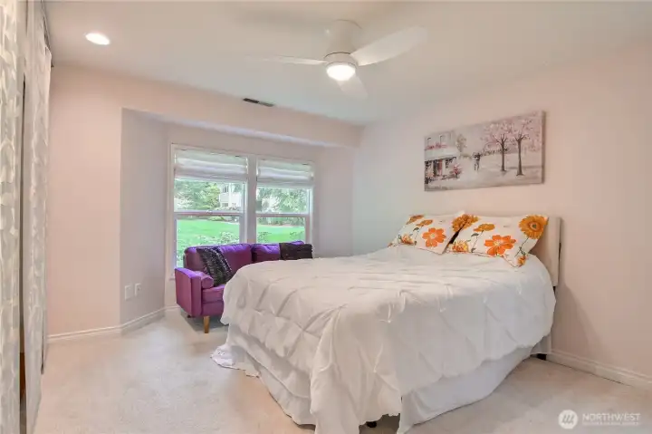 Primary bedroom suite with ceiling fan, lots of closet space, and love views.