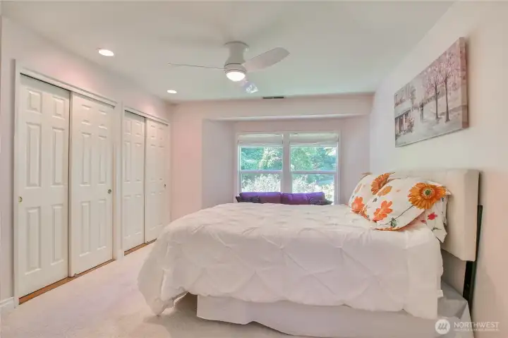 Primary suite with ceiling fan, lots of closet space, & views t o greenery. Primary suite with ceiling fan, lots of closet space, & views t o greenery.