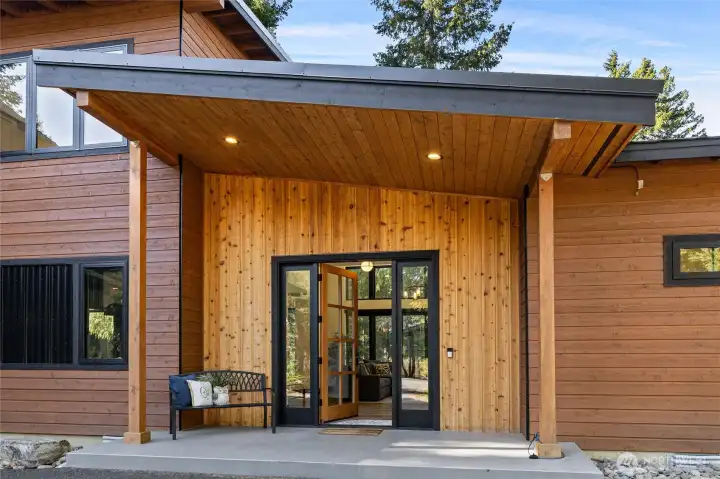 Striking wood and black metal accents at the entryway establish the home’s distinctive style and set the tone for its overall design.