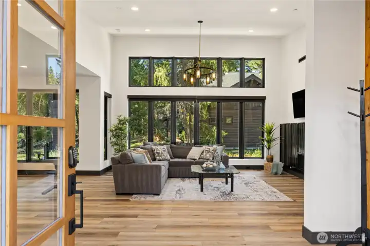 Soaring windows fill the main living area with abundant natural light, creating a bright and open atmosphere that beckons you in.