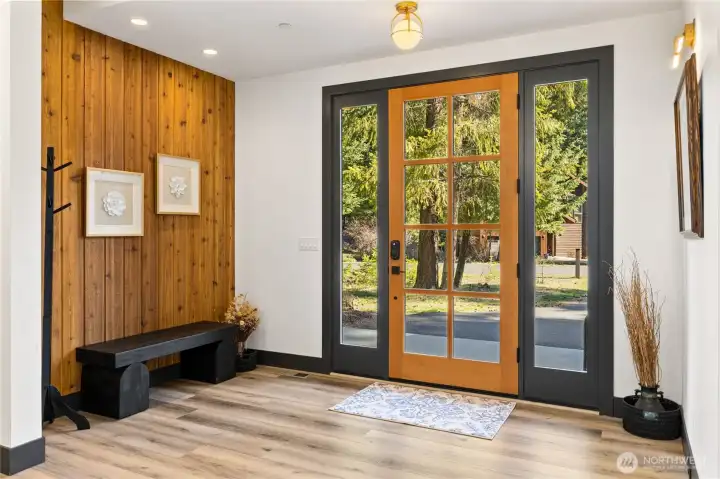 A tasteful wood feature wall at the entry provides a beautiful and striking contrast.