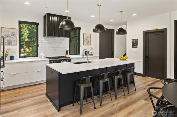 Crisp white cabinetry is beautifully complemented by quartz countertops and a classic subway tile backsplash.