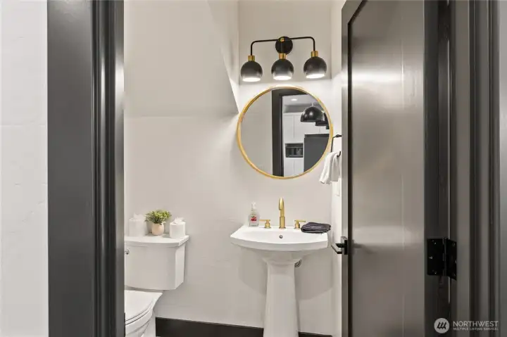 A conveniently located half bath sits just off the main living area, near the stairwell.