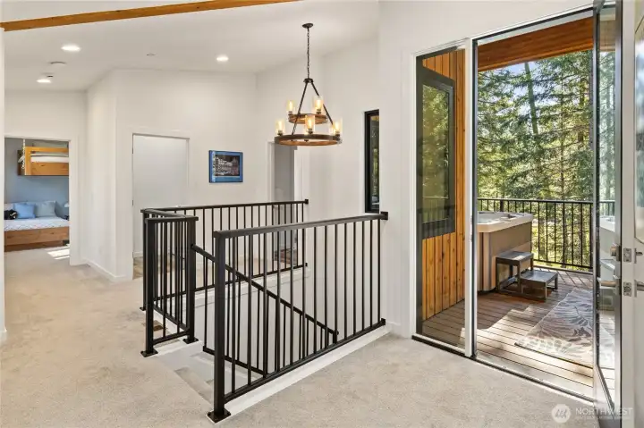 The second story includes three bedrooms, two bathrooms, a laundry room, and convenient access to the hot tub deck.