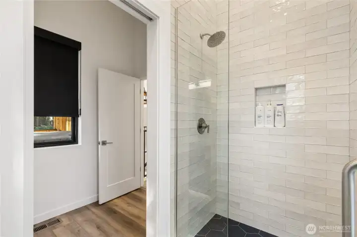 The beatiful shower tile adds a touch of elegance and style to the space.