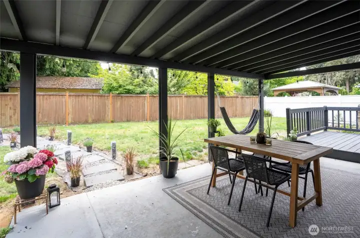 Back covered patio with paver walkway to fire pit