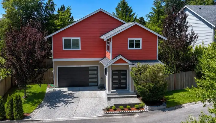Modern two-story home featuring a spacious driveway, attached garage, and private fenced setting. Modern two-story home featuring a spacious driveway, attached garage, and private fenced setting.
