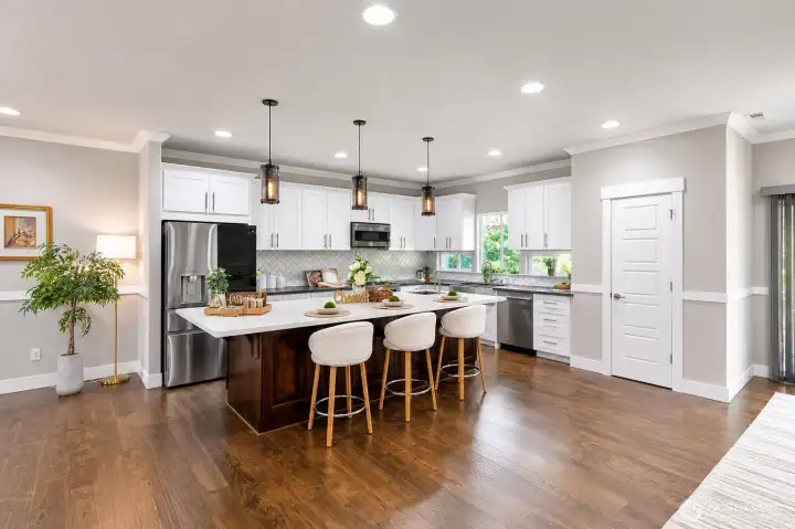 Gourmet kitchen with oversized island, pendant lighting, and abundant cabinetry. Gourmet kitchen with oversized island, pendant lighting, and abundant cabinetry.