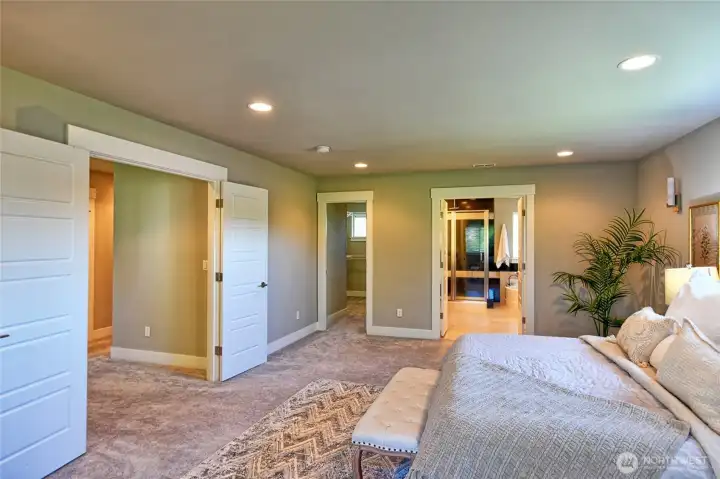 Walk-in closet and large primary bathroom.