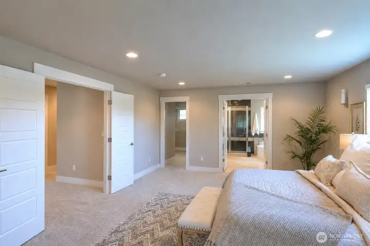 Walk-in closet and large primary bathroom. Walk-in closet and large primary bathroom.